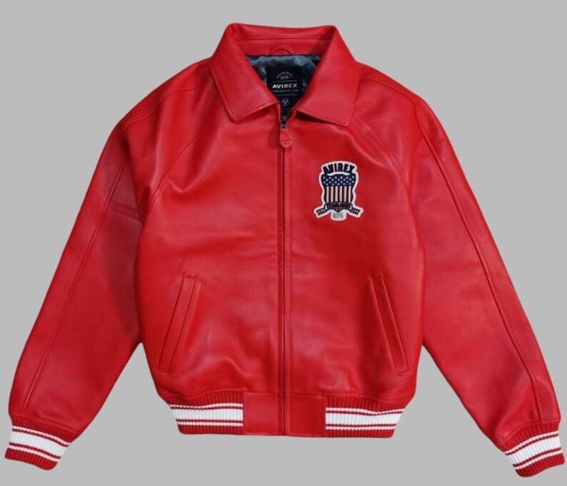 Premium Avirex USA red leather jacket with embroidered logo detailing, classic bomber style, ribbed cuffs and hem, high-quality craftsmanship.
