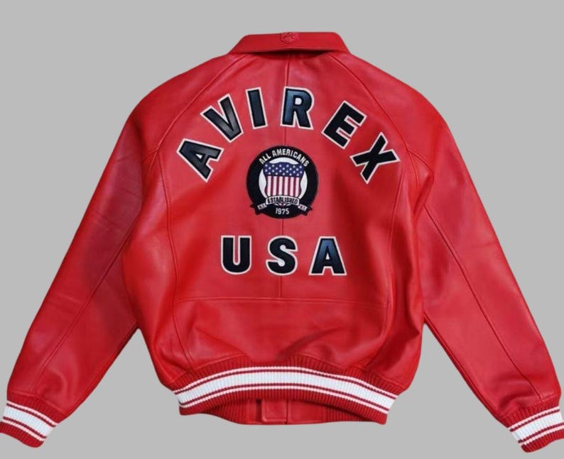 Premium Avirex USA red leather jacket with embroidered logo detailing, classic bomber style, ribbed cuffs and hem, high-quality craftsmanship.