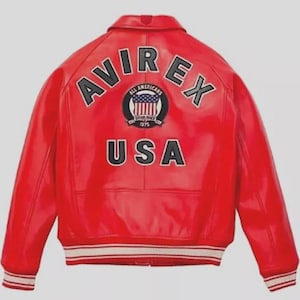 Premium Avirex USA red leather jacket with embroidered logo detailing, classic bomber style, ribbed cuffs and hem, high-quality craftsmanship.