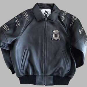 Black Avirex leather jacket featuring bold embroidered Avirex LDN lettering on the back, classic bomber style, ribbed cuffs and hem, premium craftsmanship.