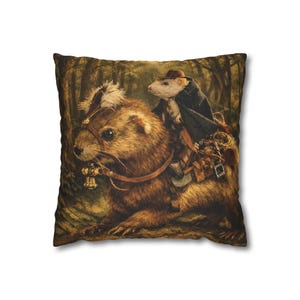 May include: Square throw pillow featuring a whimsical illustration of a rodent riding a larger animal through a forest. The rider wears a hat and cloak, while the animal has a bridle with bells. The pillow has a dark, textured background.