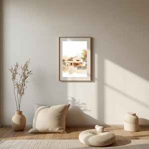 Peut inclure: Une impression d'art murale encadrée présentant une illustration à l'aquarelle d'une maison moderne aux lignes épurées et aux tons beige chaud. L'œuvre est présentée dans un cadre en bois simple, mettant en valeur des éléments architecturaux.