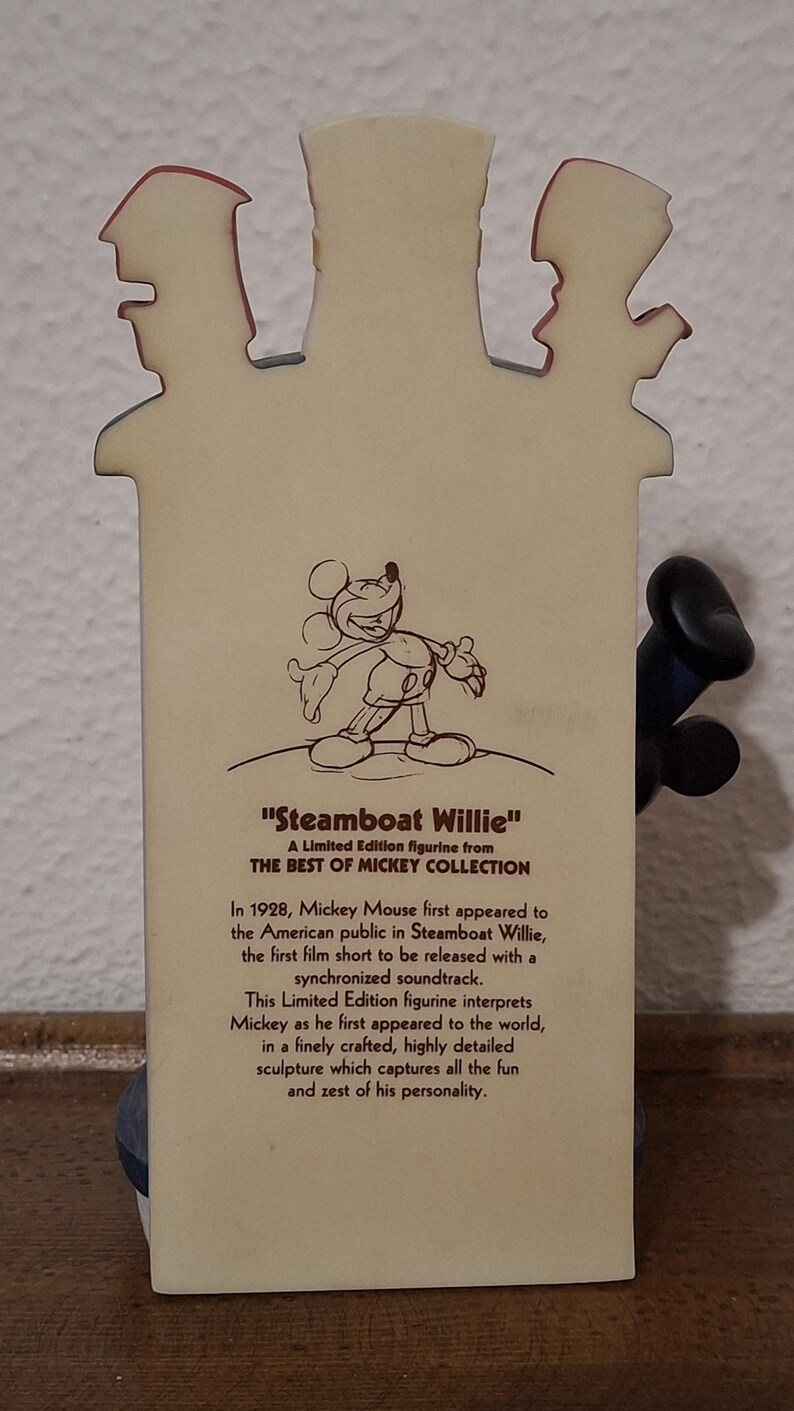May include: A limited edition figurine from the Best of Mickey Collection, featuring Mickey Mouse from "Steamboat Willie." The figurine depicts Mickey's first appearance, with text describing the film and figurine's details.