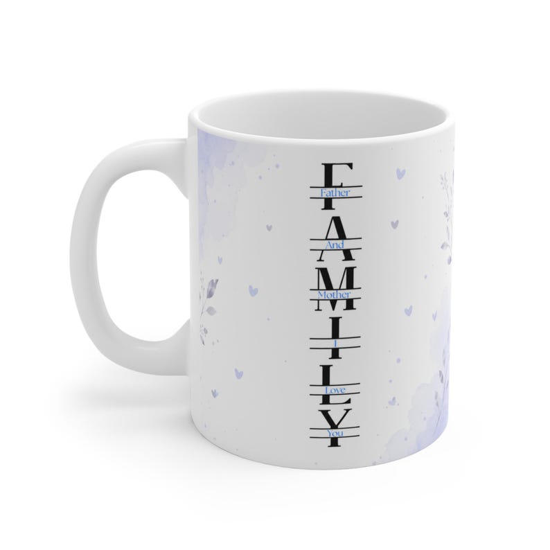 May include: A white ceramic mug featuring a vertical black text design that spells FAMILY with the words Father, And, Mother, I, Love, You integrated horizontally between the letters. The mug has a light purple watercolor floral pattern.