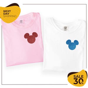two t-shirts with Mickey Mouse designs, one pink and one white, along with a yellow and black sale label indicating a 30% discount.