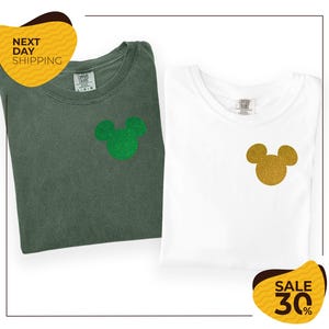 two t-shirts with Mickey Mouse designs, one green and one white, along with a yellow and black sale tag indicating a 30% discount.
