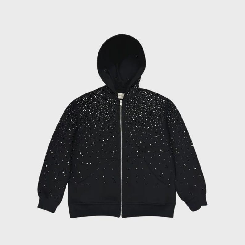 May include: Black zip-up hoodie with a constellation-like pattern of white dots. The hoodie features a full-length zipper, a hood, and two front pockets. The design is a unique take on a classic outerwear piece.