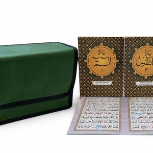 May include: A green fabric carrying case with black trim positioned next to two brown books featuring gold geometric patterns and Arabic script on the covers, accompanied by an open page displaying colour-coded Arabic text and Tajweed rules.