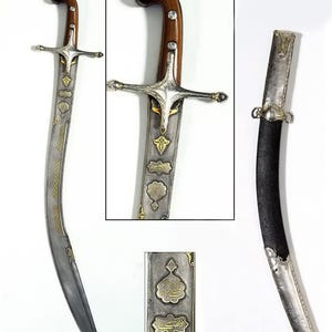 May include: An antique saber with a curved blade, wooden handle, and ornate silver and gold detailing. The scabbard is black with silver accents. The blade has etched designs and the handle features a crossguard.