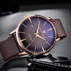 Può includere: Una tazza di ceramica bianca con manico nero e la scritta "But First, Coffee" in nero, in grassetto. La tazza è appoggiata su una superficie di legno.