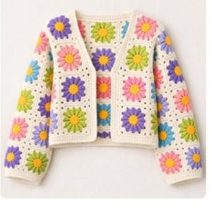 May include: A cream-coloured crochet cardigan with daisy squares. The daisies have yellow centres and pink, purple, green, and blue petals. The cardigan has long sleeves and a V-neck.
