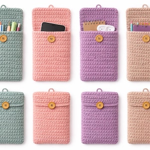 May include: A selection of handmade crochet pouches in shades of teal, pink, purple, and beige. Each pouch has a button fastening and a hanging loop. Some pouches are open, displaying items such as pens, a phone, and a notepad.
