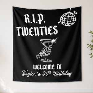 May include: A black rectangular wall tapestry featuring white graphic elements including a disco ball, a skeleton hand holding a martini glass, and the text R.I.P. TWENTIES WELCOME TO Taylor's 30th Birthday in a mix of gothic and script fonts.