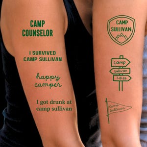 May include: Green temporary tattoos with camp-themed designs. Text includes "Camp Counselor," "I Survived Camp Sullivan," "Happy Camper," and "I got drunk at camp sullivan." Other designs include a shield, directional signs, and a pennant.