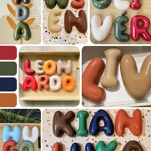 May include: A collection of glossy, three-dimensional balloon-style letters in various colors including red, green, blue, orange, brown, and white. These individual letters are arranged to spell names such as Ada, Wsloven, Oliver, Leonardo, Liv, Hugo, Kian, and Luka.
