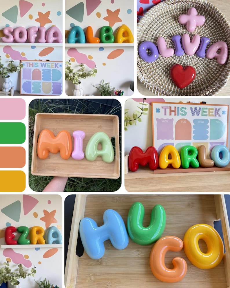 May include: A collection of glossy, three-dimensional, bubble-style letters in various bright colors, used to spell names like Sofia, Alba, Olivia, Mia, Marlo, Ezra, and Hugo. These smooth, rounded decorative letters are displayed on shelves, in wooden trays, or in woven baskets.