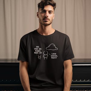 May include: A black t-shirt featuring a white line-art graphic of a child asking, "Dad, what are clouds made of?" and an adult figure replying, "Linux servers, mostly," positioned below a simple cloud illustration on the chest.