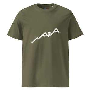 May include: Olive green t-shirt featuring a white graphic of a cyclist riding up a mountain range. The design is simple and clean, perfect for outdoor enthusiasts. The shirt is made of a soft, comfortable material.