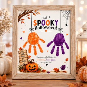 May include: A framed print featuring the text HAVE A SPOOKY Halloween! with an orange handprint and a purple handprint hanging from strings. It includes a wooden sign reading LITTLE HANDS CREATE BIG MAGIC, a jack-o'-lantern, and autumn leaves.