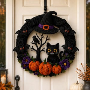 May include: A black crocheted Halloween wreath featuring a witch hat, four small bats with red eyes, a black cat, a black bird on a tree branch, three orange pumpkins, and purple flowers. The wreath is circular and hangs on a white door.