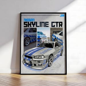 May include: A framed poster featuring the text NISSAN SKYLINE GTR. The design includes three smaller photographic panels of a silver car with blue racing stripes and a large central illustration of the same silver sports car with blue stripes.