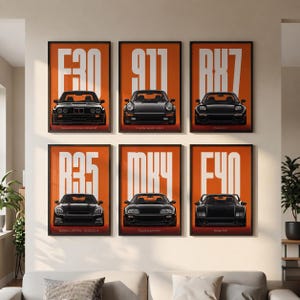 May include: A set of six framed wall art prints featuring black sports cars on orange backgrounds with white text. The prints display the E30, 911, RX7, R35, MK4, and F40 models, each labeled with its respective name and model designation.