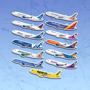 May include: A collection of airplane stickers featuring various airline logos, including United, American, Southwest, and Spirit. The stickers are white with colorful designs and logos, set against a blue background with a map pattern.