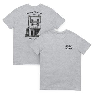 May include: Two heather gray t-shirts. One displays a detailed black and white illustration of a building with the text "Dixie Liquor" and "Georgetown". The other shirt has the text "Dixie Liquor Est. 1934" in black.