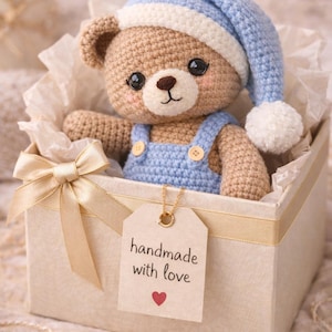 Handmade crochet teddy bear amigurumi, dressed in soft blue overalls and a matching nightcap. This adorable bear makes a perfect baby shower