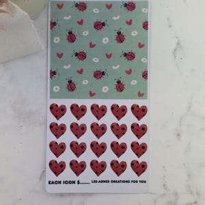 May include: A rectangular sticker sheet with two designs. The top half has a light green background with ladybirds, hearts, and daisies. The bottom half shows red heart stickers with black polka dots. Text at the bottom reads "EACH ICON $...... LEE-ARNES CREATIONS FOR YOU."