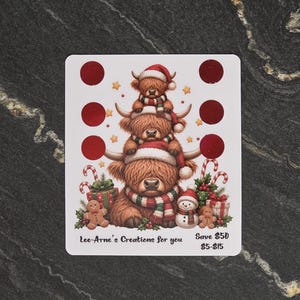 May include: A rectangular sticker sheet featuring three stacked Highland cows wearing Santa hats and striped scarves, surrounded by gingerbread men, candy canes, and gift boxes. The text reads Lee-Arne's Creations for you, Save $50, $5-$15.