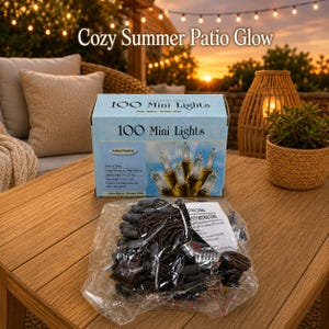 May include: A box of 100 mini lights with clear bulbs and brown wire, featuring a total length of 7.4 metres and a lighted length of 7.3 metres. The set includes a plastic bag containing the string of lights and a printed instruction sheet.