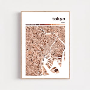May include: A framed print featuring a detailed map of Tokyo, Japan, in shades of brown and white. The city's name is displayed in a modern font above the map, with the country's name below. Coordinates are shown at the top.