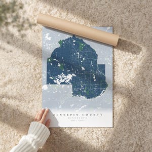 Puede incluir: Una taza de cerámica blanca con un asa negra y el texto "But First, Coffee" en un estilo manuscrito. La taza está sobre una superficie blanca. La taza mide aproximadamente 10 cm de alto.