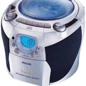 May include: Silver and black Philips boombox with a CD player and digital display. The boombox has a blue-lit display showing the number 18. The text "bembo" and "DYNAMIC BASS BOOST" are visible.