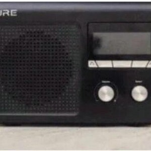 May include: Black digital radio with the word "PURE" at the top. The radio features a speaker, a digital display, and two silver knobs for volume and tuning. The radio is rectangular with rounded corners.