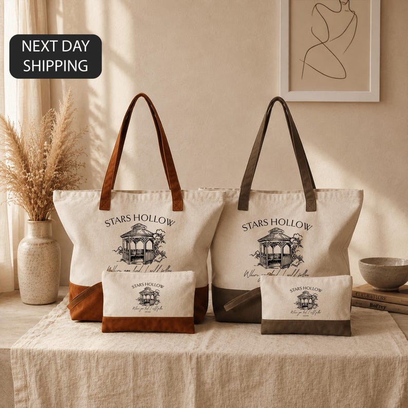 a set of two tote bags and a small bag, all featuring the same design and text, placed on a table.