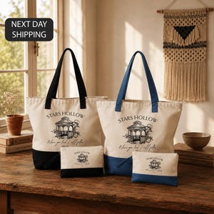 a set of tote bags and a small bag on a wooden table, with a window and a woven wall hanging in the background.