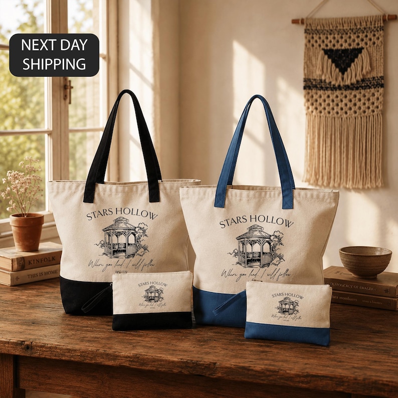 a set of tote bags and a small bag on a wooden table, with a window and a woven wall hanging in the background.