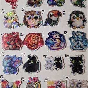 May include: A collection of twenty numbered stickers featuring various cartoon animals and creatures, including birds, dragons, a butterfly, a unicorn, and ducks, with holographic accents on many designs, arranged in a grid on a white background.