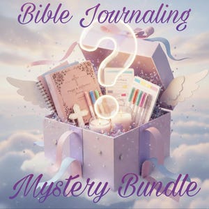 May include: A gift box labeled "Mystery Bundle" filled with Bible journaling supplies. Includes a pink journal, pens, candles, and a cross. The words "Bible Journaling" are at the top.