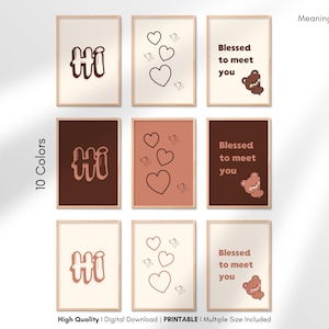 May include: Nine framed art prints in various colors, each with a different design. The prints feature the word "Hi", hearts, and the phrase "Blessed to meet you" with a bear illustration. The prints are available in 10 colors.