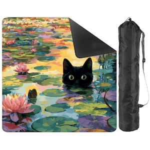 May include: A yoga mat featuring a colorful painting of a black cat in a pond with lily pads and pink flowers. A black carrying bag with a shoulder strap is included.