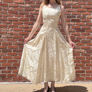 Vintage 1950’s sleeveless wedding dress with leaf pattern and gold details, size xs