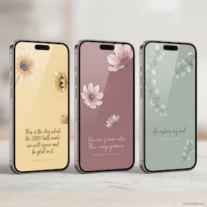 May include: Three smartphones with floral wallpaper designs. One phone has sunflowers and the text "This is the day which the LORD hath made; we will rejoice and be glad in it." Another has pink flowers and the text "You are of more value than many sparrows." The third has green leaves and the text "He restores my soul."