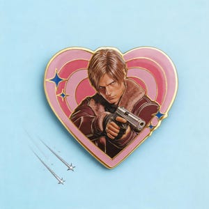 May include: A heart-shaped enamel pin featuring a character with light brown hair wearing a brown jacket with a fur collar, holding a silver handgun. The background of the pin consists of concentric pink heart rings and small blue four-pointed stars.