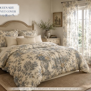 May include: A queen size duvet cover featuring a cream background with a blue and tan floral toile pattern. The bedding set includes matching pillow shams and a solid cream rectangular accent pillow. Text reads QUEEN SIZE DUVET COVER.