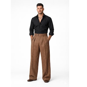 May include: A black long-sleeved shirt and brown wide-leg trousers. The trousers feature a pleated front and a high waist. The outfit is completed with brown shoes and a silver necklace. The clothing is suitable for a formal or semi-formal occasion.
