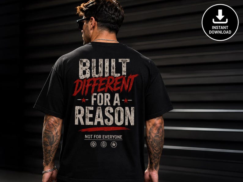 May include: A black short-sleeved t-shirt featuring the white and red distressed text BUILT DIFFERENT FOR A REASON, with the smaller text NOT FOR EVERYONE below it, along with three small circular icons featuring a barbell, a target, and a star.