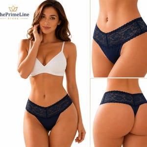 May include: A white bralette with a V-neckline paired with navy blue underwear featuring a wide lace waistband. The set is shown from the front and back, highlighting the solid fabric construction and the intricate floral lace detailing.